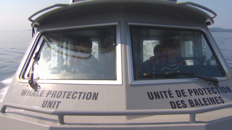 A boat with the words 'Whale Protection Unit' on it sails in water.