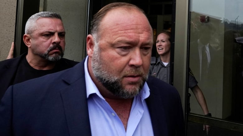 Alex Jones arrives at court for his defamation trial. 