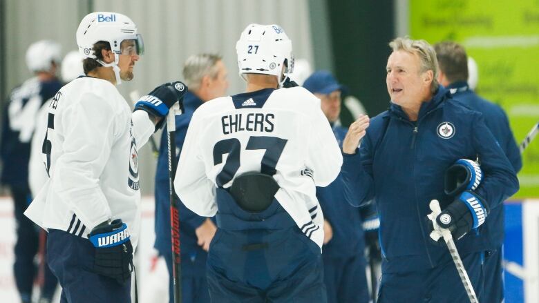 New Winnipeg Jets head coach Rick Bowness talks with Nikolaj Ehlers and Mark Scheifele during opening day of their NHL training camp Thursday.