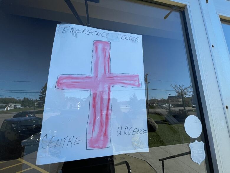 A hand-drawn sign of a red cross with 