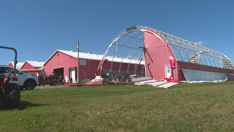 A tarp barn with most of the siding torn off from the winds from Fiona 