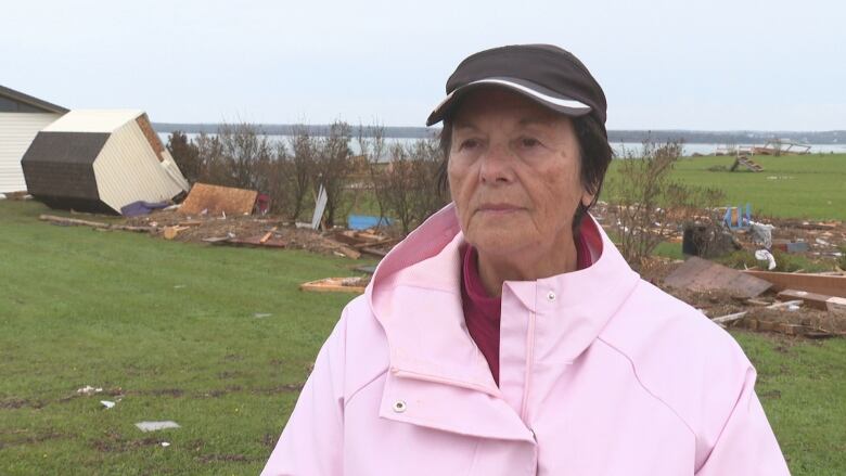 Myrna Gough with debris in background.