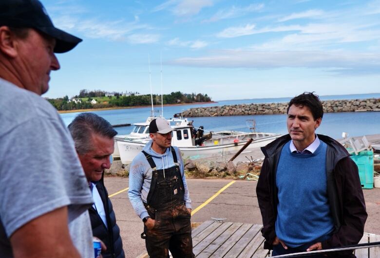 Prime Minister Justin Trudeau speaking to people in a fishing community.