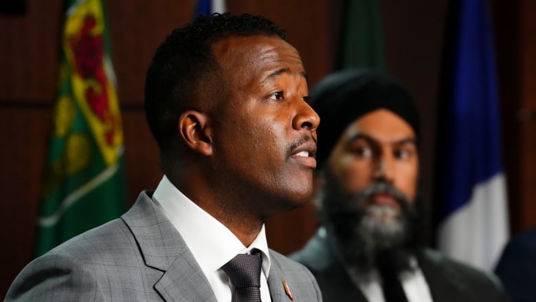 NDP leader Jagmeet Singh, right, looks on as he joins Nicholas Marcus Thompson, Executive Director of the Black Class Action Secretariat to hold a press conference on Parliament Hill in Ottawa on Wednesday, Sept. 28, 2022. 