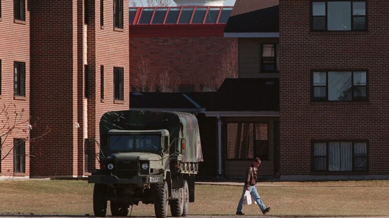 A soldier walks home with his groceries in front of the military housing at CFB Borden near Barrie, Ontario on Monday April 5, 1999.