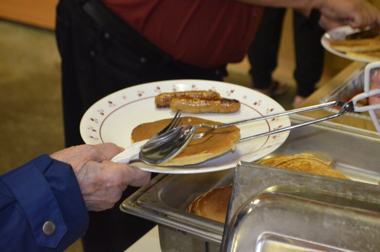 Pancakes, sausages and fruit are served for dinner one Tuesday night at 