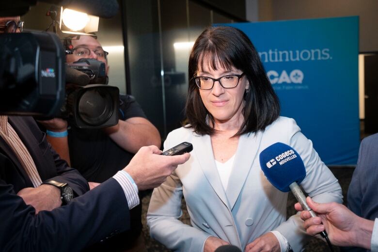 Sonia LeBel was re-elected as the CAQ MNA for Champlain. She is seen here speaking to reporters at the party's first post-election caucus meeting on Oct. 6, 2022.