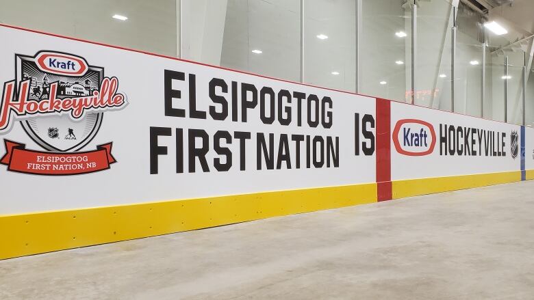 Hockey boards in a rink that say Elsipogtog First Nation is Hockeyville.