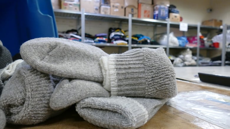 Pairs of socks sit on a table.