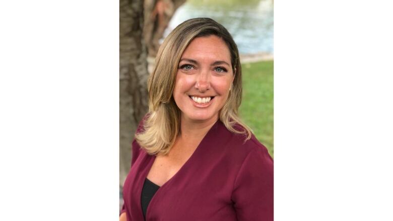 Larissa Vogler in a red shirt photographed outside. 