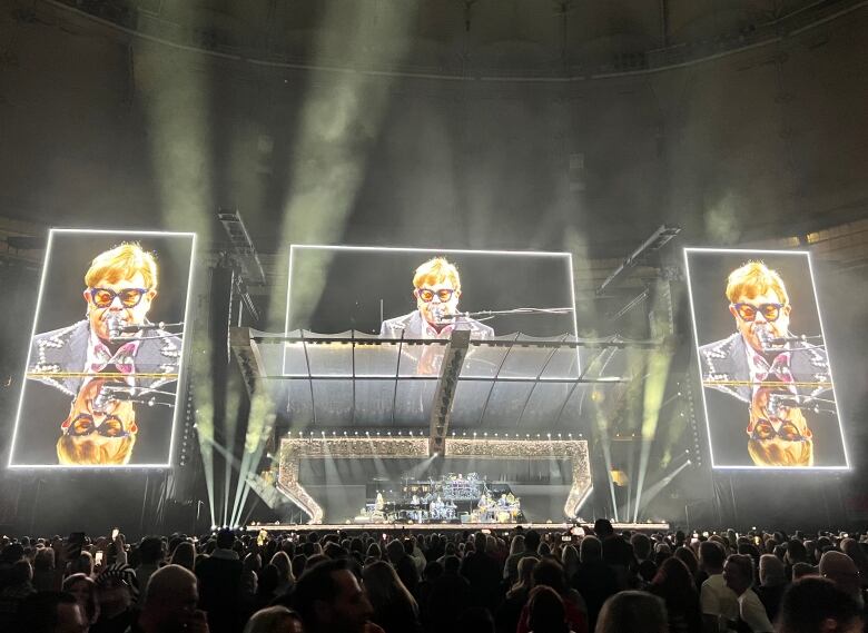 A concert screen with Elton John.