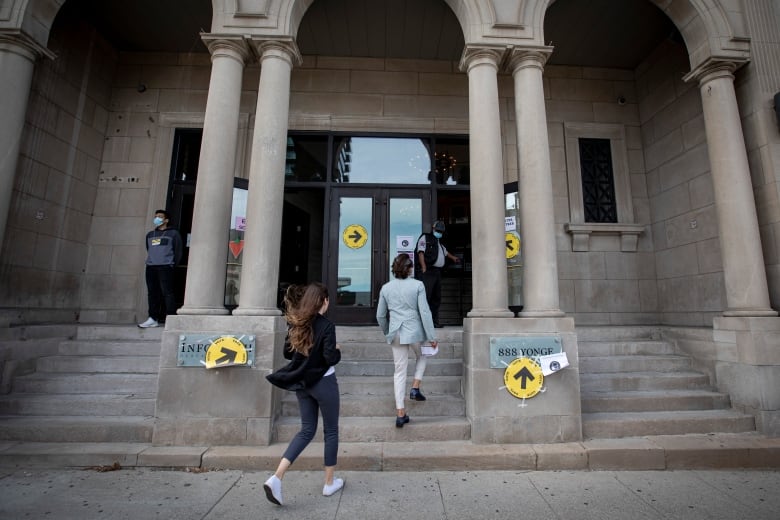 Voters line up to cast ballots at a University-Rosedale polling station, in Toronto, on Sept. 20, 2021  Election Day in Canadas 44th federal election. A variety of challenges with municipal elections tend to hinder candidates from connecting with voters. 