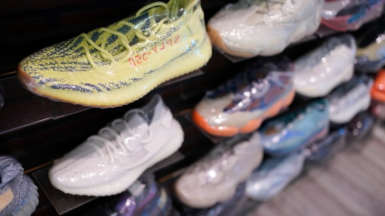 Sneakers on a display wall in a store.