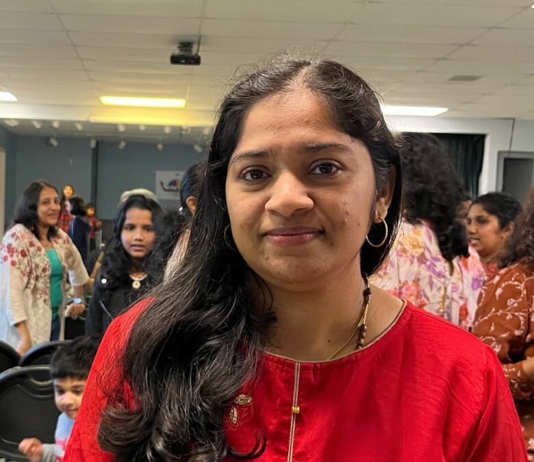 A woman smiles into the camera.