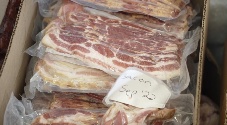 Bacon in a freezer labeled September 2022. 