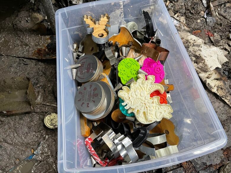 A bin of colourful cookie cutters.