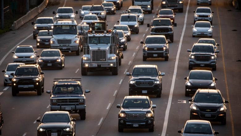 Dozens of cars lined up in traffic.