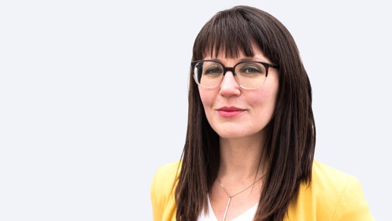 Photo of woman wearing a yellow jacket on a white background