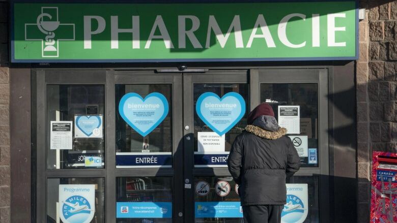 A person walks into a pharmacy