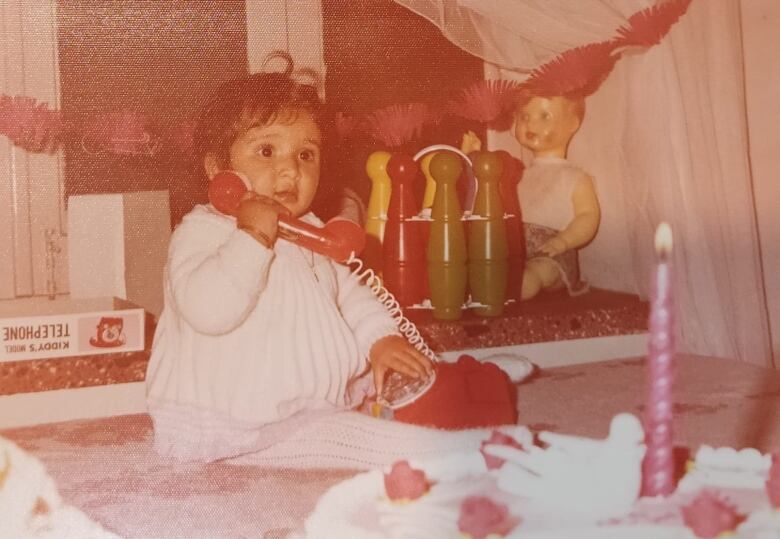 A baby answers a toy phone