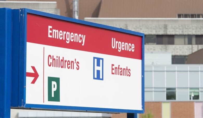 A sign directs visitors to the emergency department at a children's hospital.