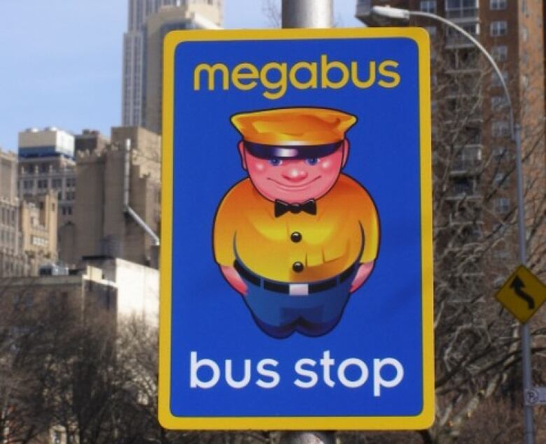 A Megabus sign with a cartoon bus driver.