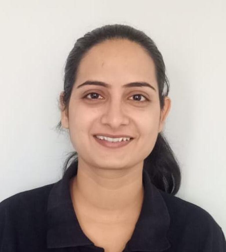 A South Asian woman smiles in a headshot.