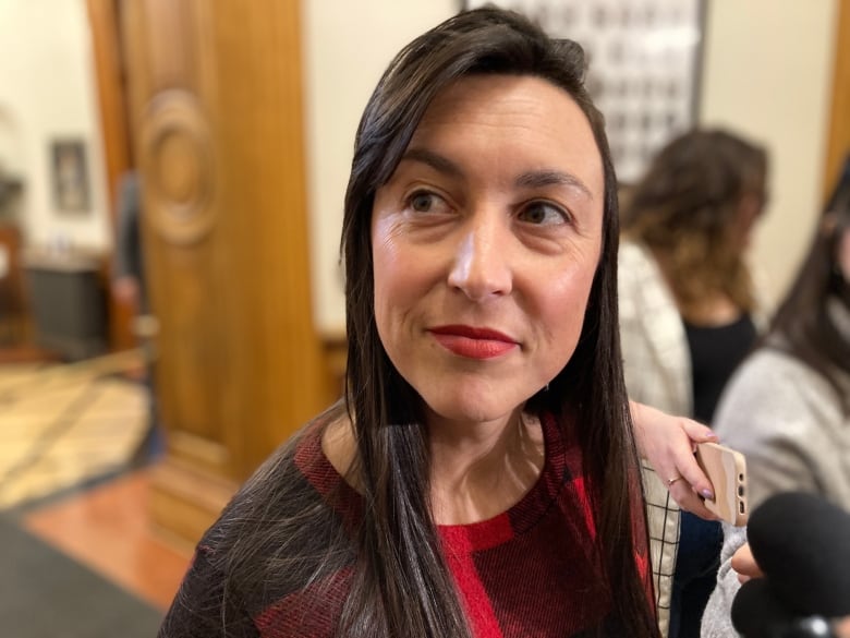 A woman with long black hair looking slightly off to the side