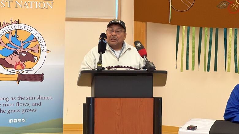 Yellowknives Dene First Nation Chief Fred Sangris of Ndilo stands at a podium.