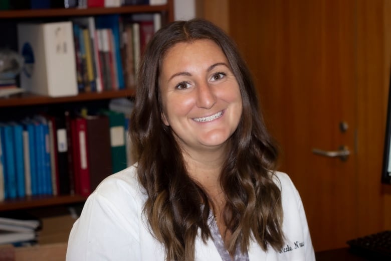 Nicole Novroski with bookcase in background.