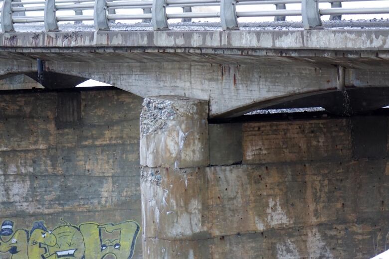 Crumbling concrete on a two-lane bridge.