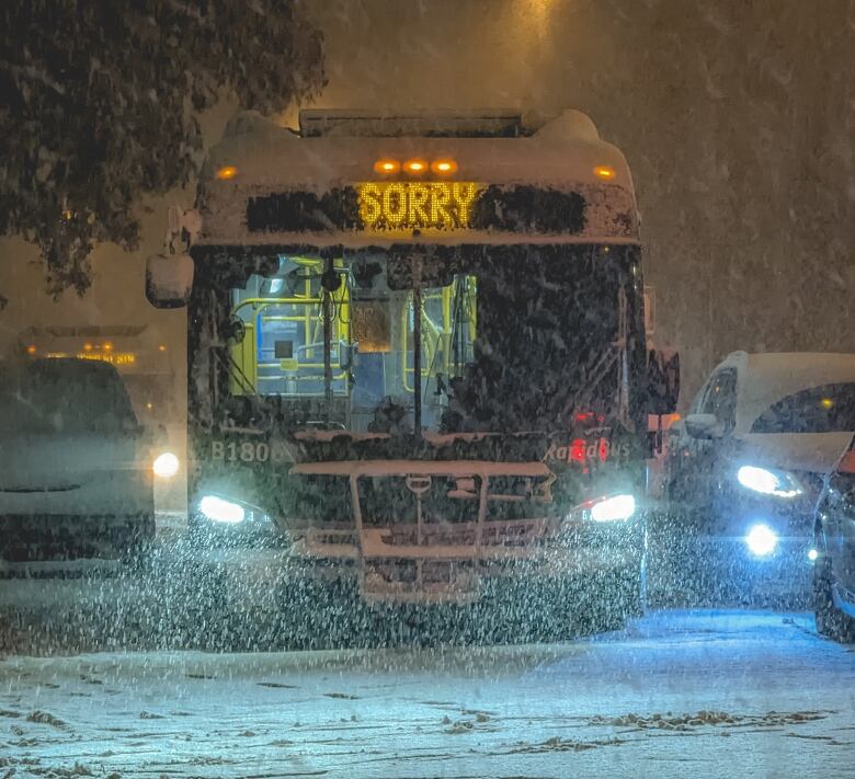 A bus in snowy weather with a chyron reading 'Sorry.'