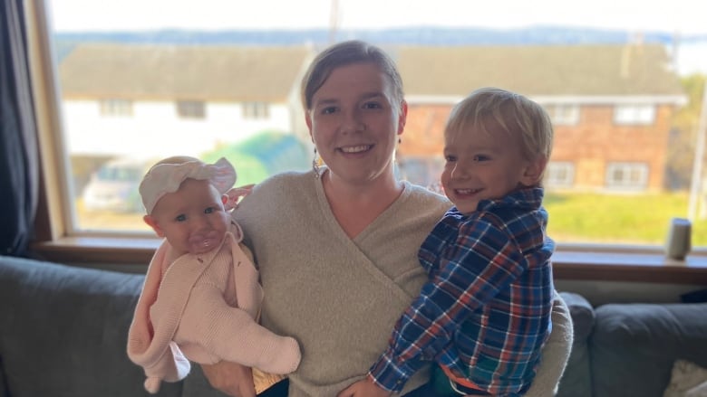 Darci Kostiuk is pictured holding her son and daughter. 