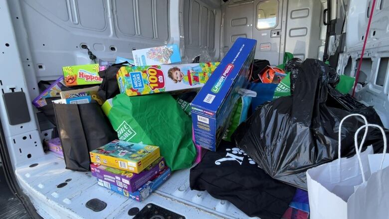 A white van is filled with children's toys for the holidays.