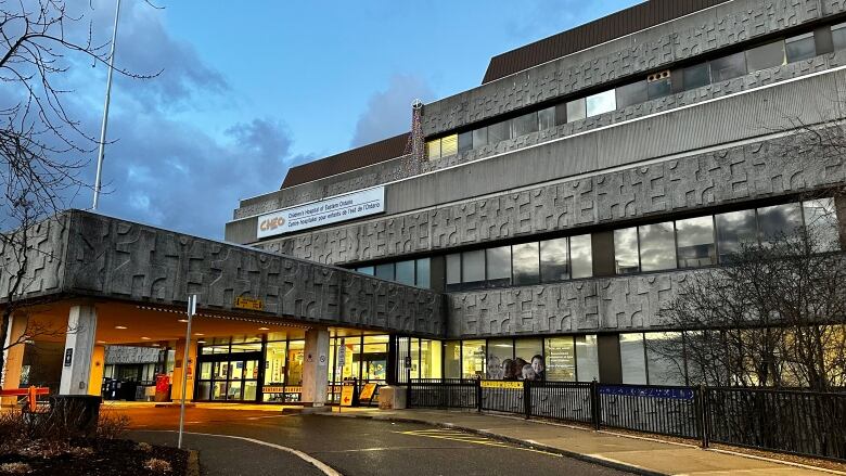 The entrance to a hospital at dusk.