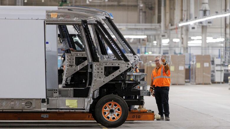 Workers assemble the components of a BrightDrop delivery van at General Motorss CAMI EV plant, in Ingersoll, Ont., on Nov. 29, 2022.