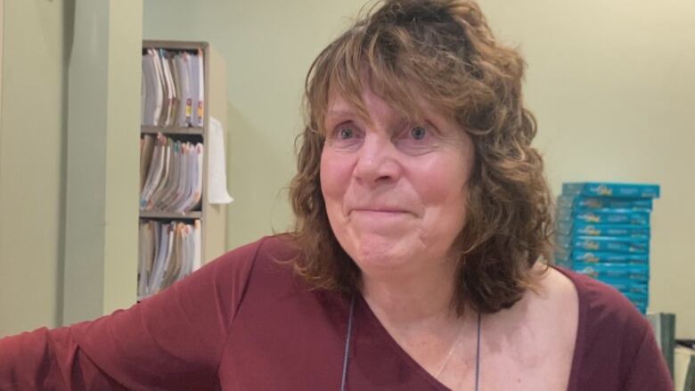 Donna Hennebury says her job at the clinic is part office manager, part receptionist and greeter, and it often means being the bearer of bad news.