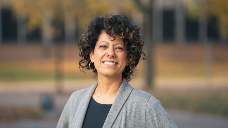  A professional headshot of a Black professor.