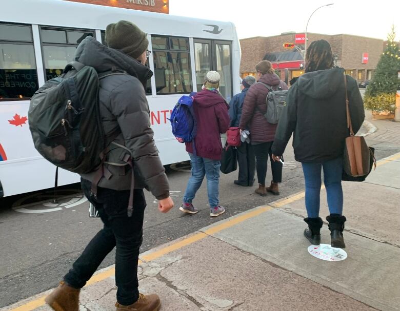 People getting on the bus 