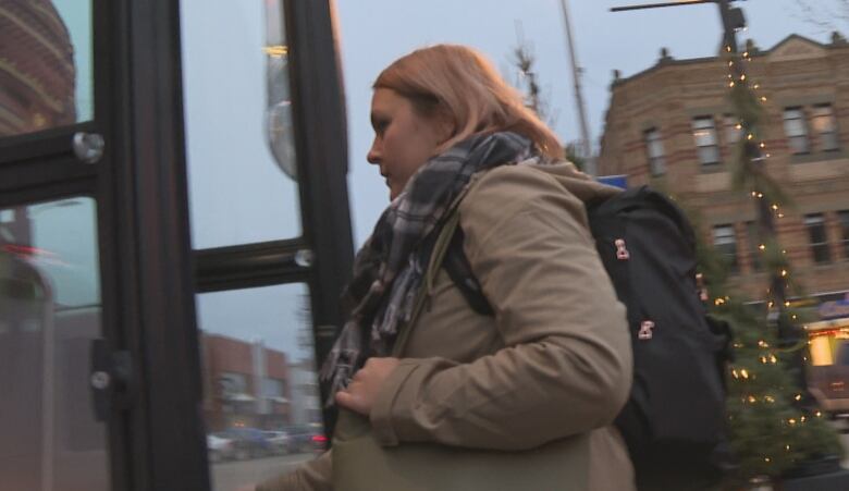 Woman getting on a bus 