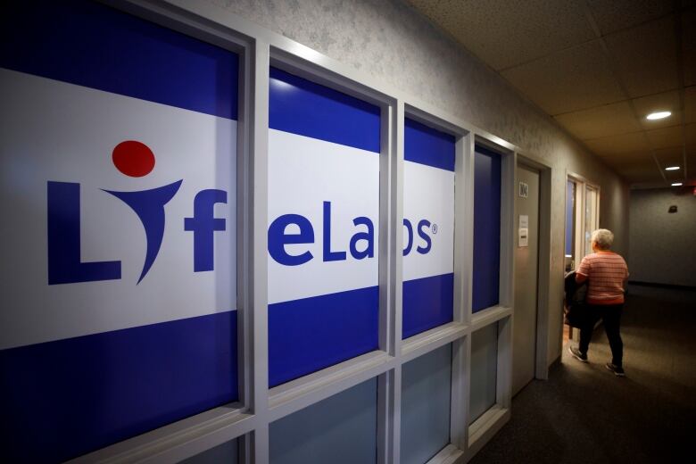 A dark hallway with a giant LifeLabs sign running nearly its entire length.