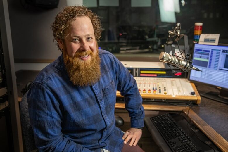 Peter Mills sits in a radio booth at CBC Saskatchewan headquarters in Regina.