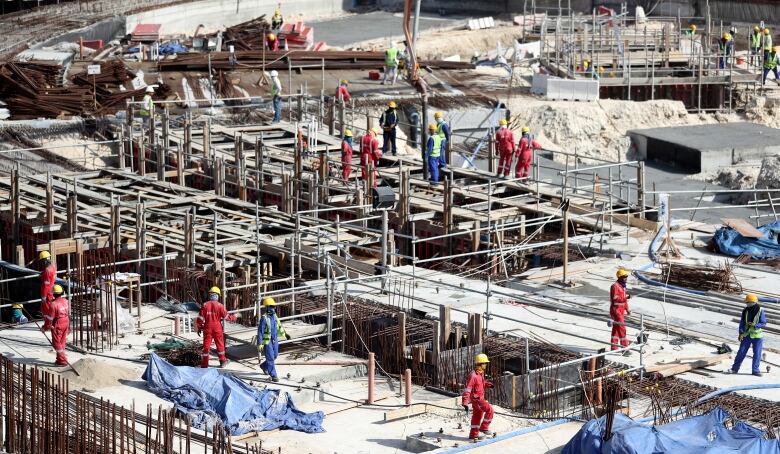 Constructions workers on unfinished building.