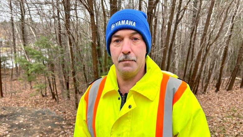 Timothy Adams stands on his property in Wellington, N.S., which he says is constantly flooding after heavy rains because water is being redirected from a nearby road construction site.