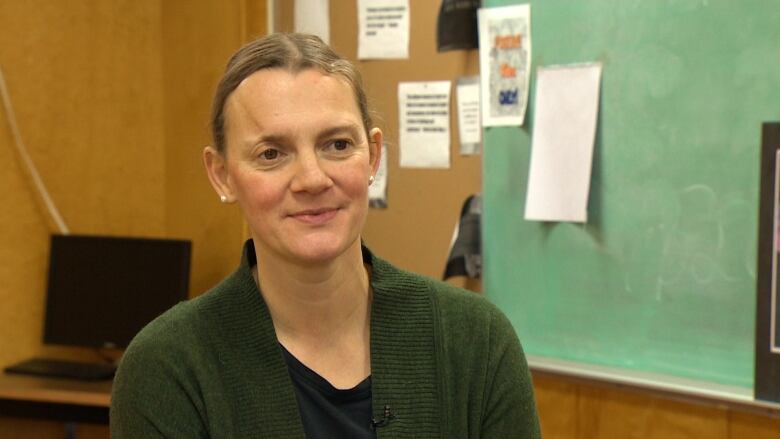 A woman smiles at the camera