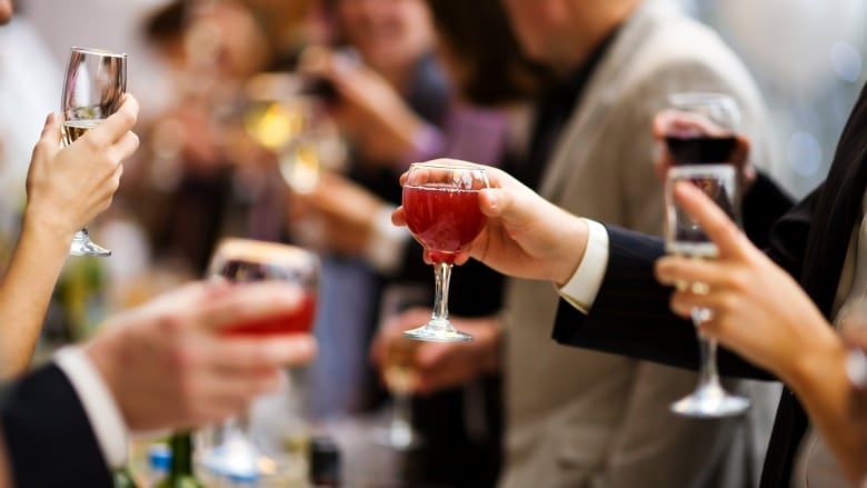 hands holds drinks at a party