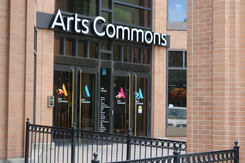 The front entrance doors of the Arts Commons building.