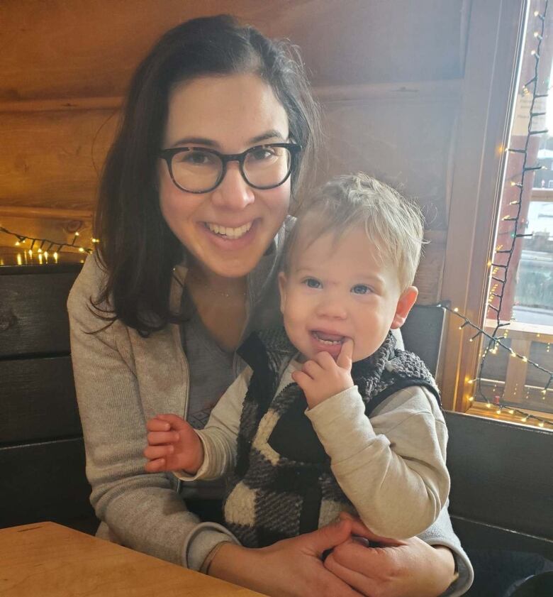 Nathalie Oldfield holds her toddler, Leeroy.