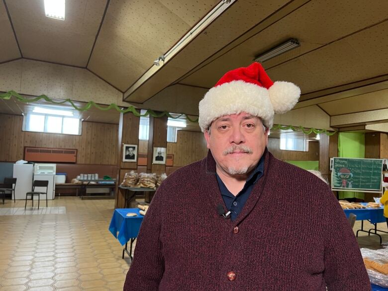 A portrait of a man wearing a Santa Claus hat. 