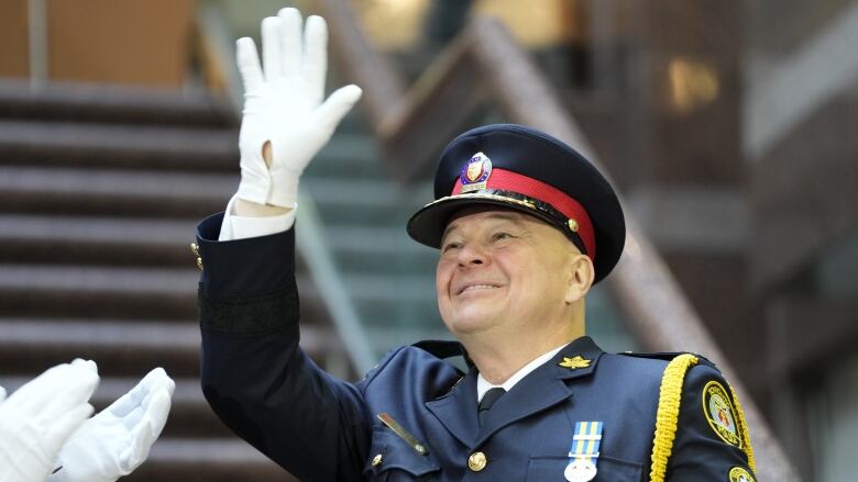 Incoming Toronto Police Chief Myron Demkiw waves after taking the oath of office during a police change of command ceremony in Toronto, Monday, Dec.19, 2022.